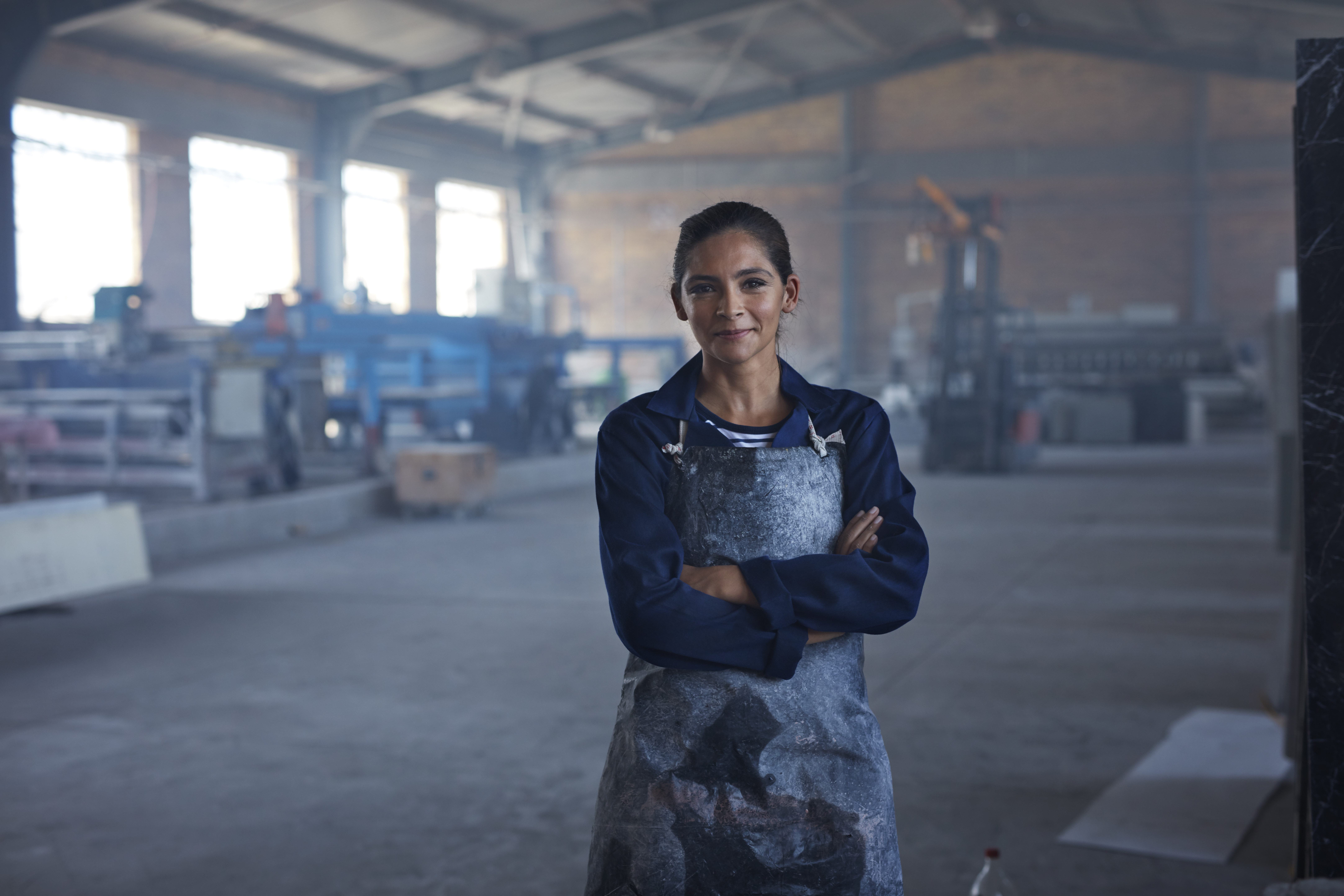 Woman wearing an apron in a warehouse