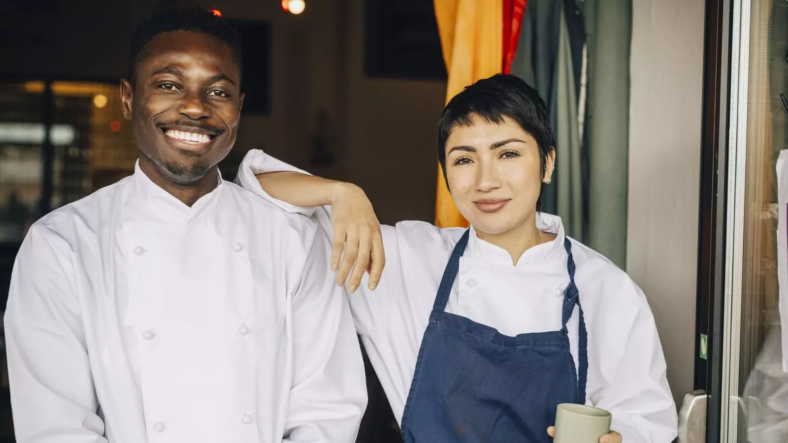 Two smiling restaurant workers
