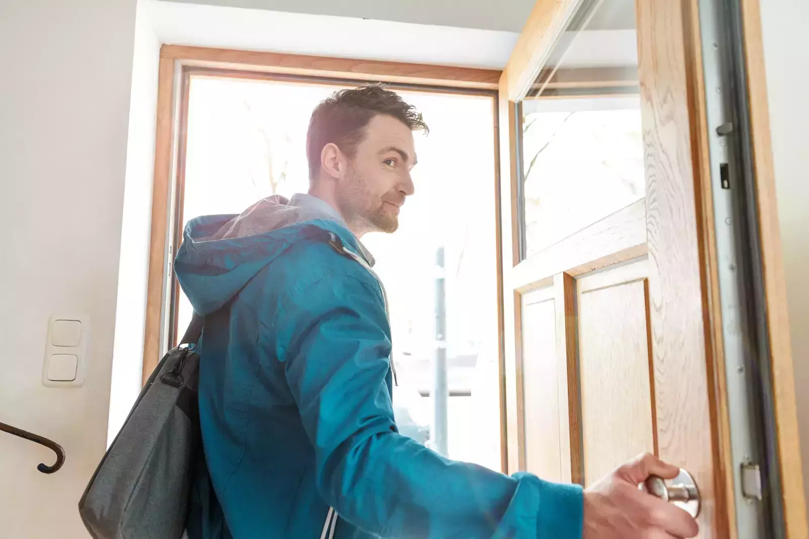 Employee with blue jacket on leaving the office unexpectedly absenteeism concept