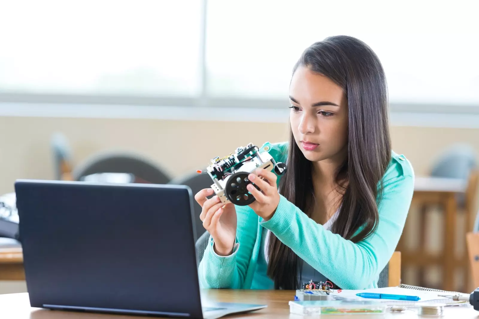 Young girl examining robotics toy