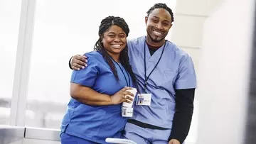 Two healthcare workers embrace