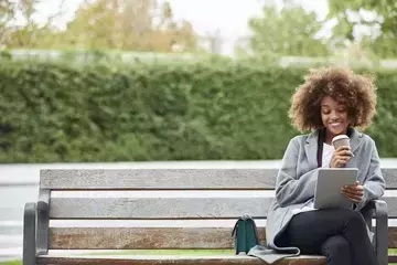 Woman on a bench with tablet