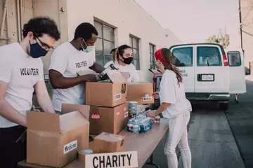 Workers packing boxes for charity