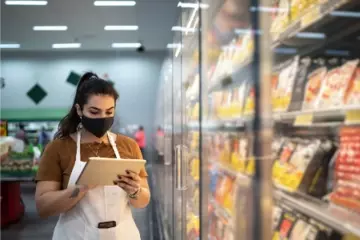 frontline employee doing inventory check in a grocery